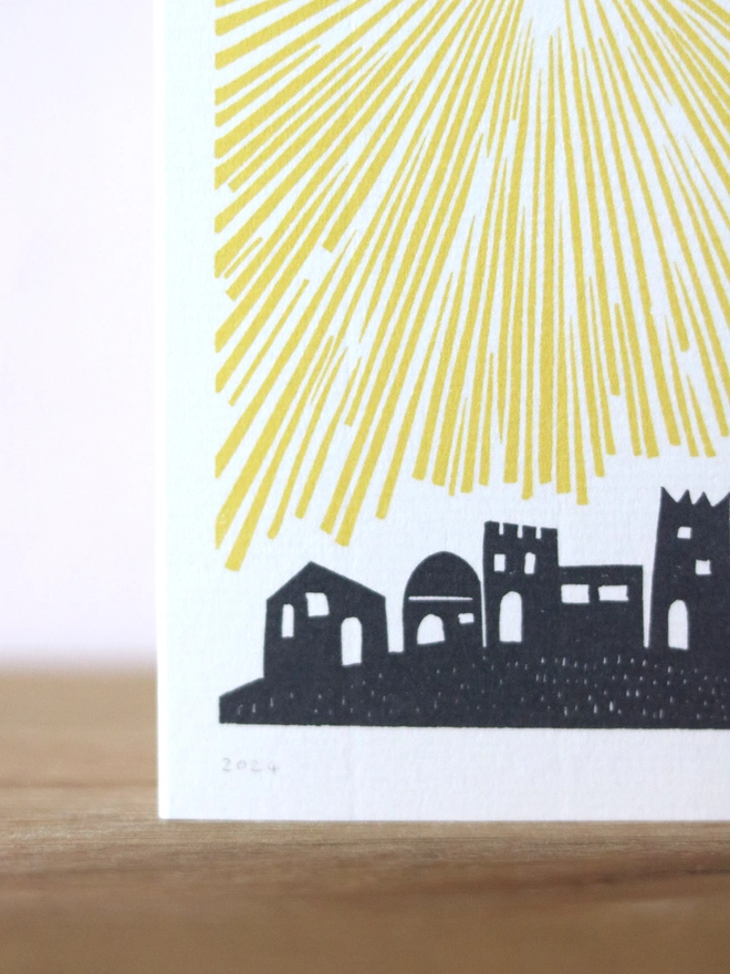 A Christmas card based on an original linocut design featuring Bethlehem and a star