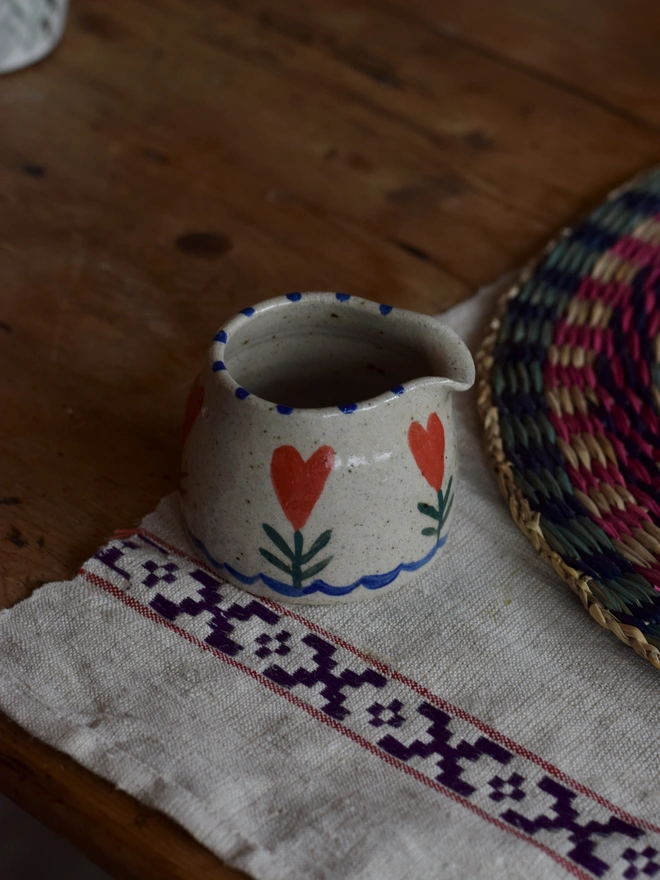 small handmade jug with heart pattern 