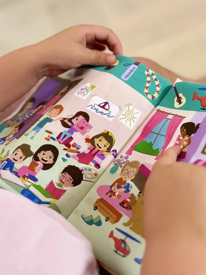 Little hand pointing at necklace on Can you find Teddy? Search and find soft book