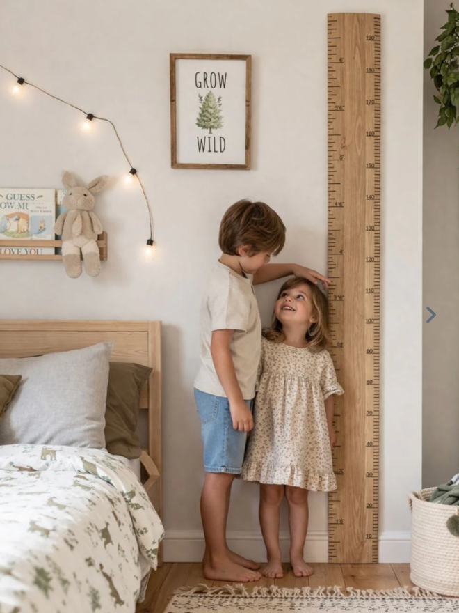 Original Ruler Height Chart. A very large wooden ruler leaning against a wall in a child’s room.