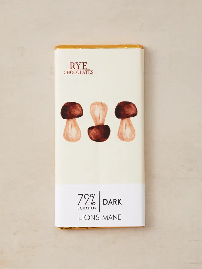 lions mane dark chocolate. a bar of chocolate in wrapping featuring illustrate mushrooms.