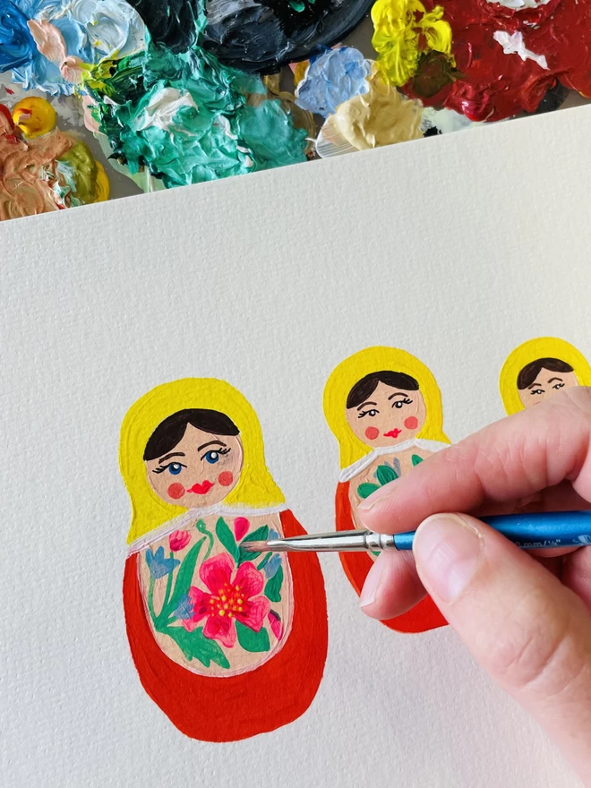 an original acryclic painting of russian dolls