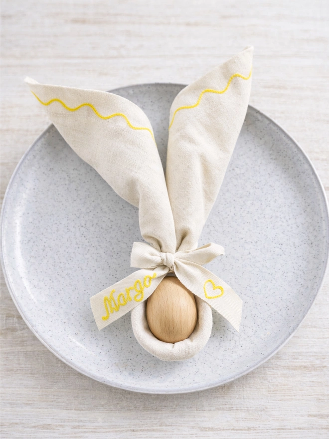 Embroidered Easter napkins with embroidered cotton twill bow with wooden egg