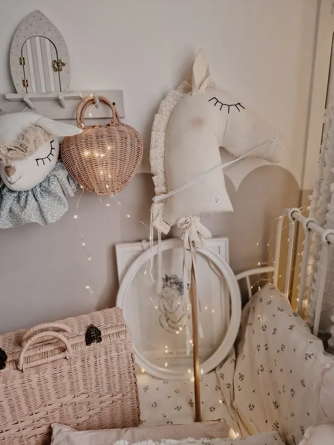 Handmade Cotton Hobby Horse Nursery Decoration, a cotton hobby horse sitting in a child's bedroom surrounded by other bedroom accessories. 