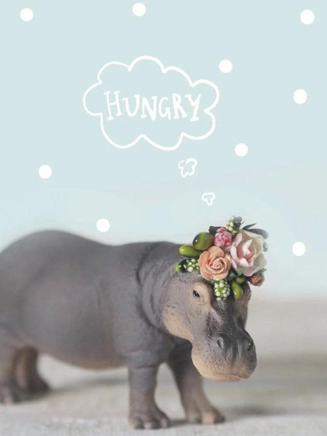 Hippo seen with a floral headdress.