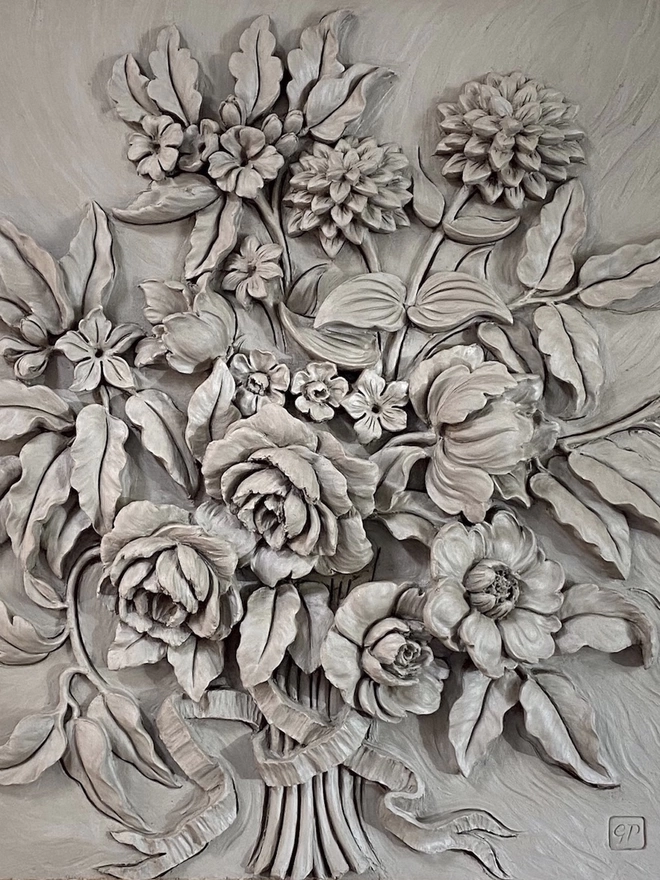 Detail of clay sculpture featuring Dahlias and Roses