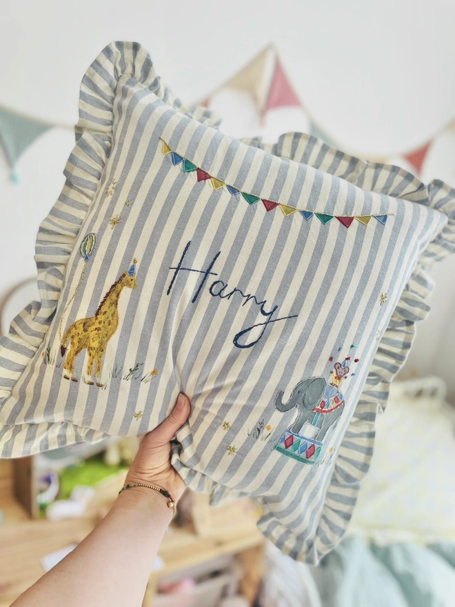 Hand Painted Giragge and ELephant celebrating the joy of the circus. Blue striped ruffle cushion with hand embroidered personalised name in the centre