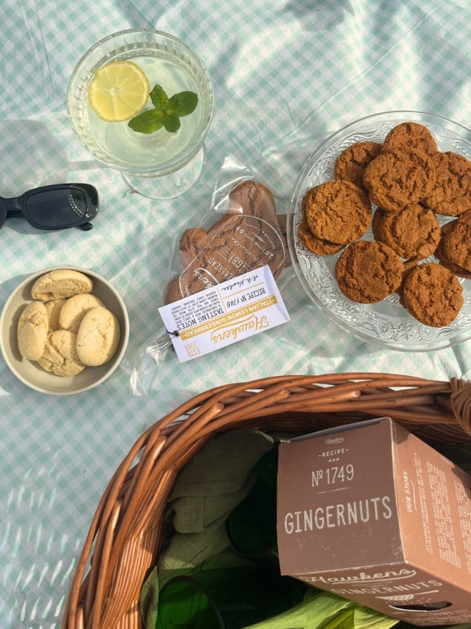 artisan gingerbread biscuit bundle in picnic basket on blue checked rug