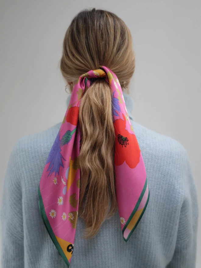 'In Bloom' Silk Scarf tied around a ponytail