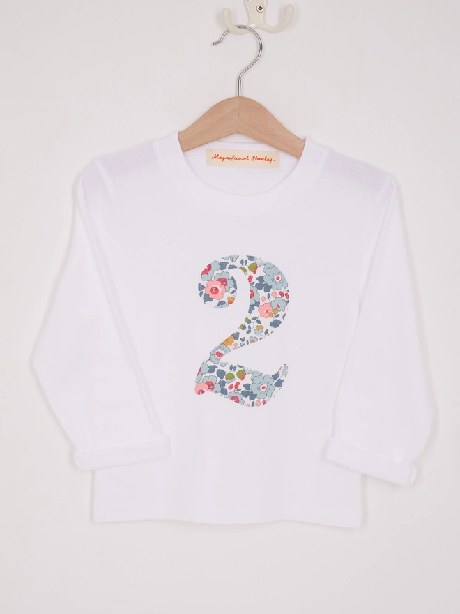 A white 2nd birthday t-shirt with a number 2 cut from liberty betsy floral print on the front