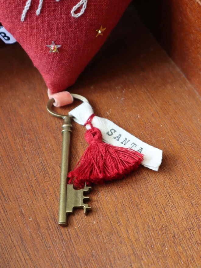 Linen heart ornament with Magic embroidery, hanging rustic key with Santa's name tag and red tassles