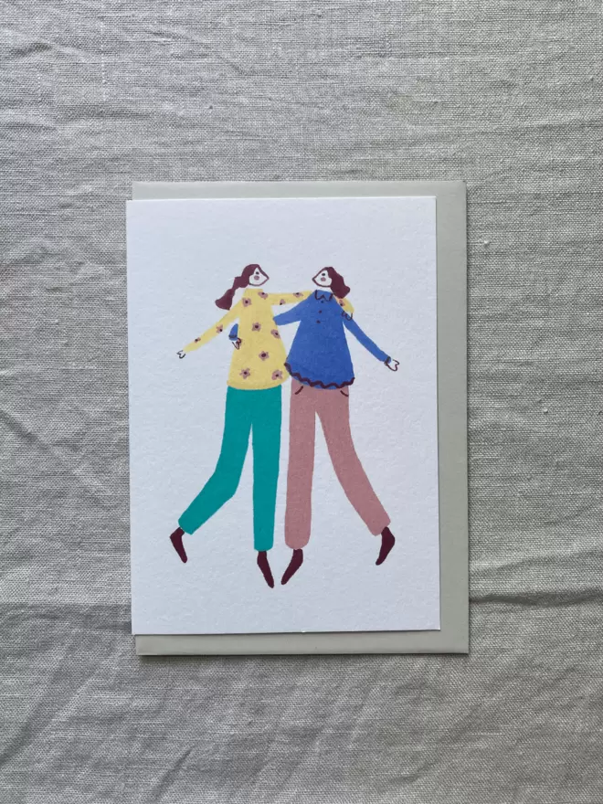 2 females hugging on a greetings card