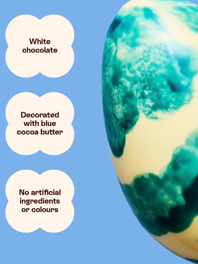 A white chocolate Easter egg decorated with blue cocoa butter