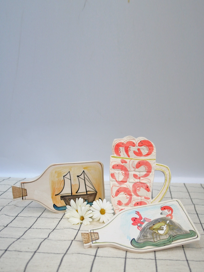 handmade ceramic wall art, seaside, ship in bottle, prawns, ceramic prawns, ceramic, crab band, wall hanging, fun ceramics