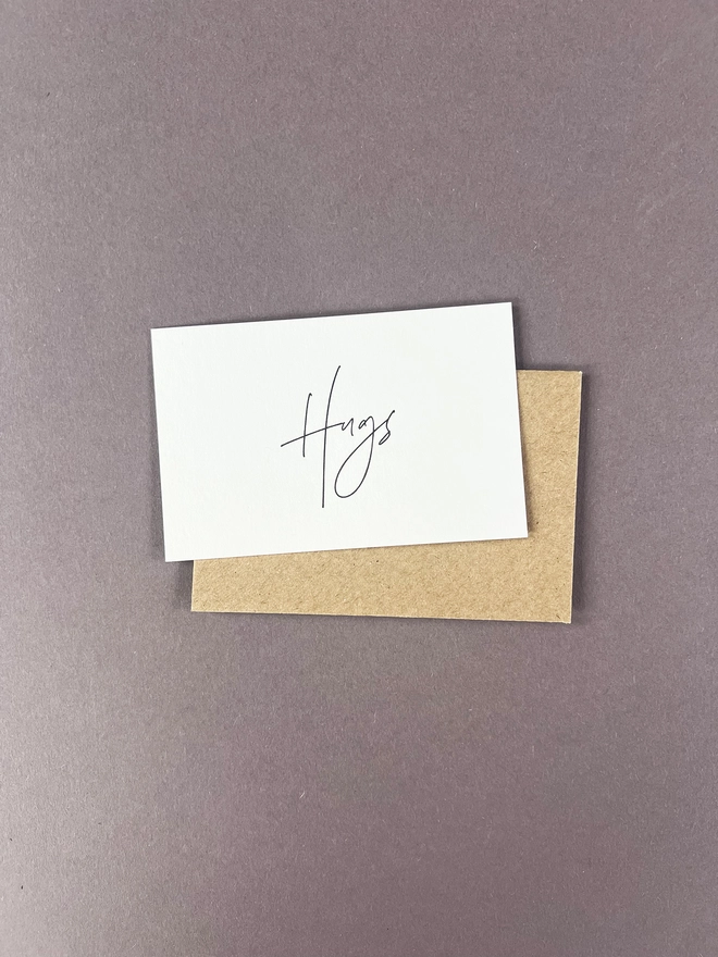 Single hug letterpress note card with modern calligraphy writing hugs on each of the 10 cards