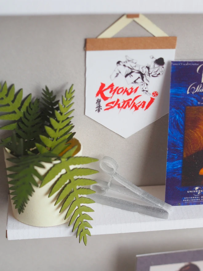 a wooden box with miniatures of the person favourite things inside. Each piece is handmade specially on request. bespoke art piece made by My Papercut Forest