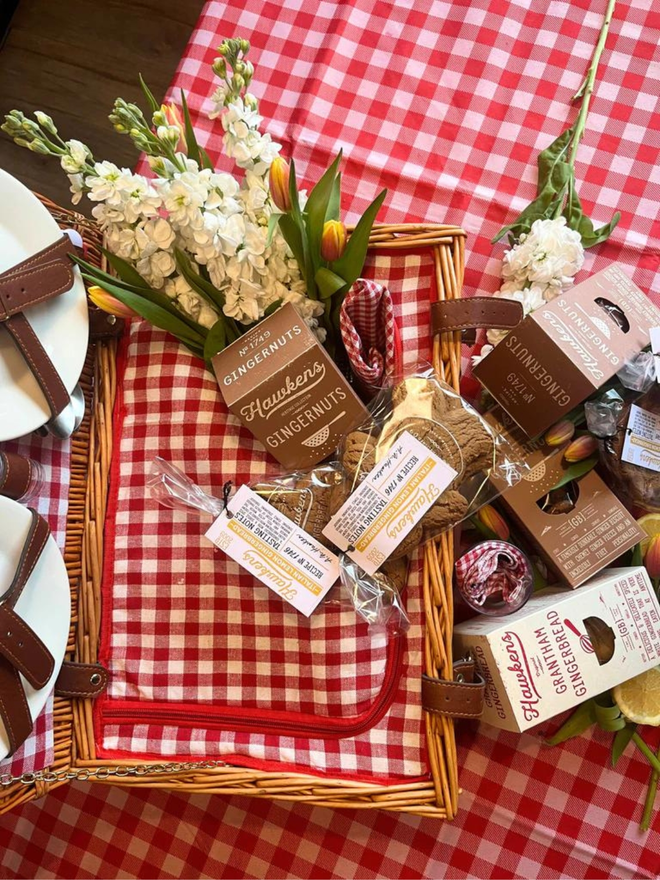 artisan gingerbread biscuit picnic bundle in wicker basket on red gingham picnic rug