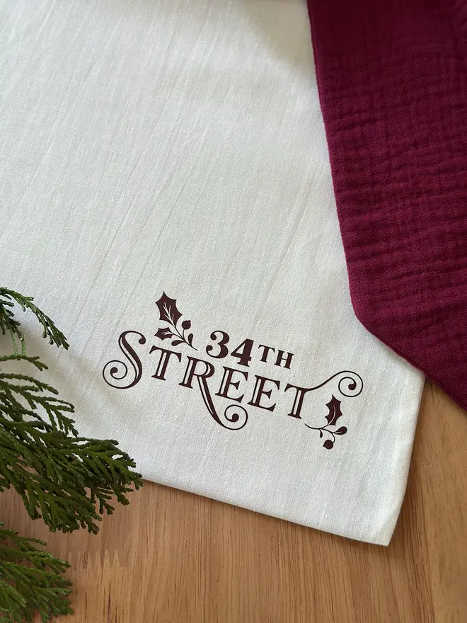 A cotton bag with the 34th Street logo on lays on a wooden desk.