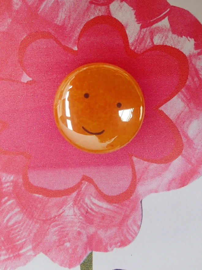 brilliant pink flower greeting card with happy face pin badge