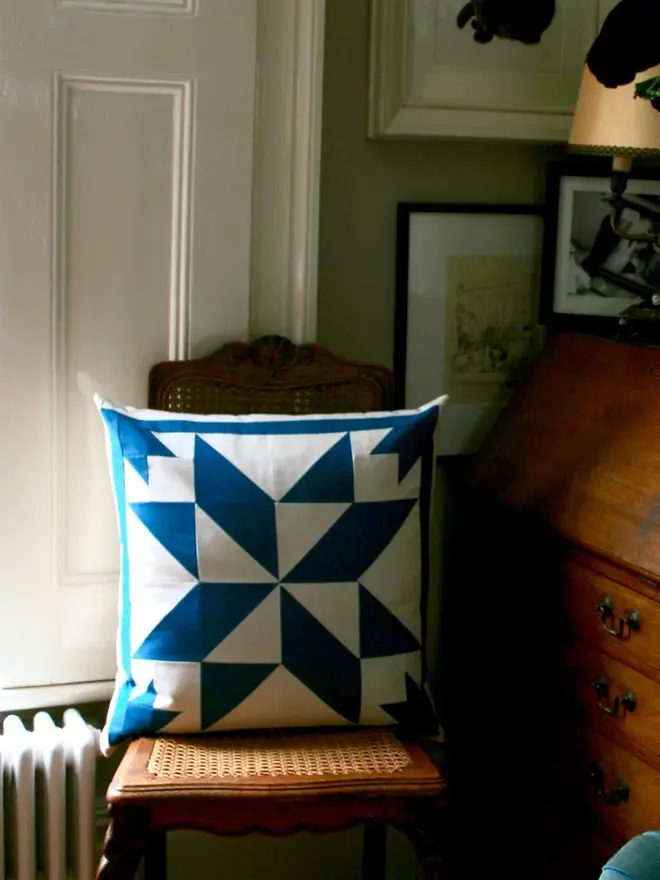Celest Patchwork Cushion, on a chair. 