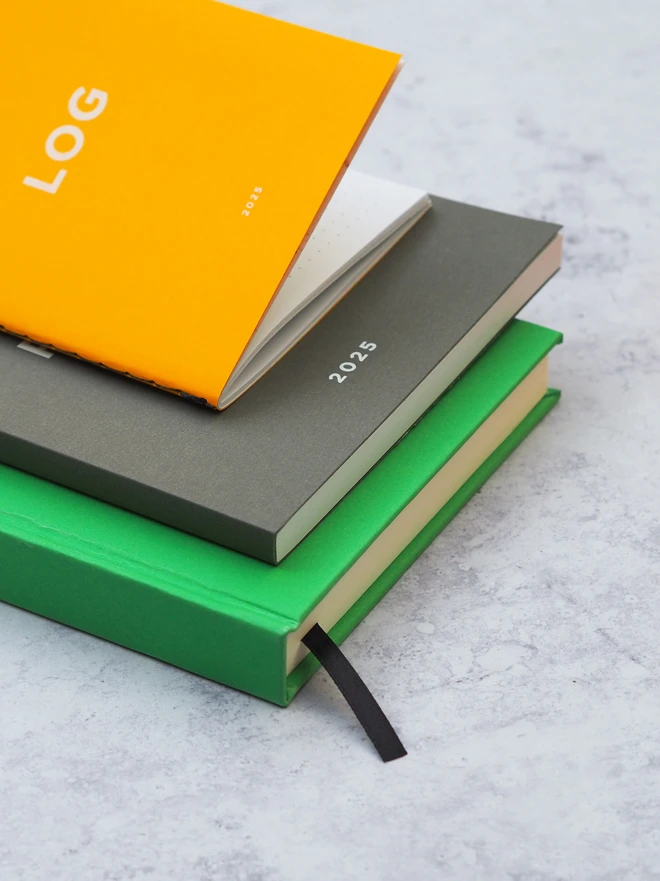 a set of personalised notebooks, showing the different formats this series comes in