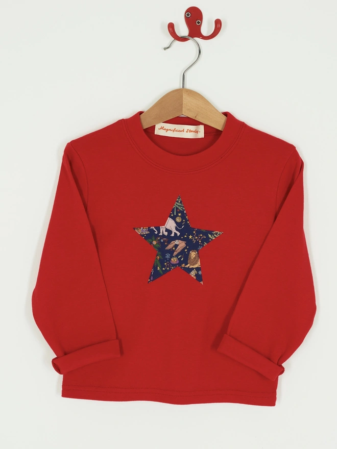 a red t-shirt with a Christmas liberty print star appliquéd on the front