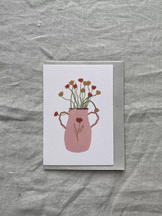 greetings card with Ranunculus flowers in a pink vase. 