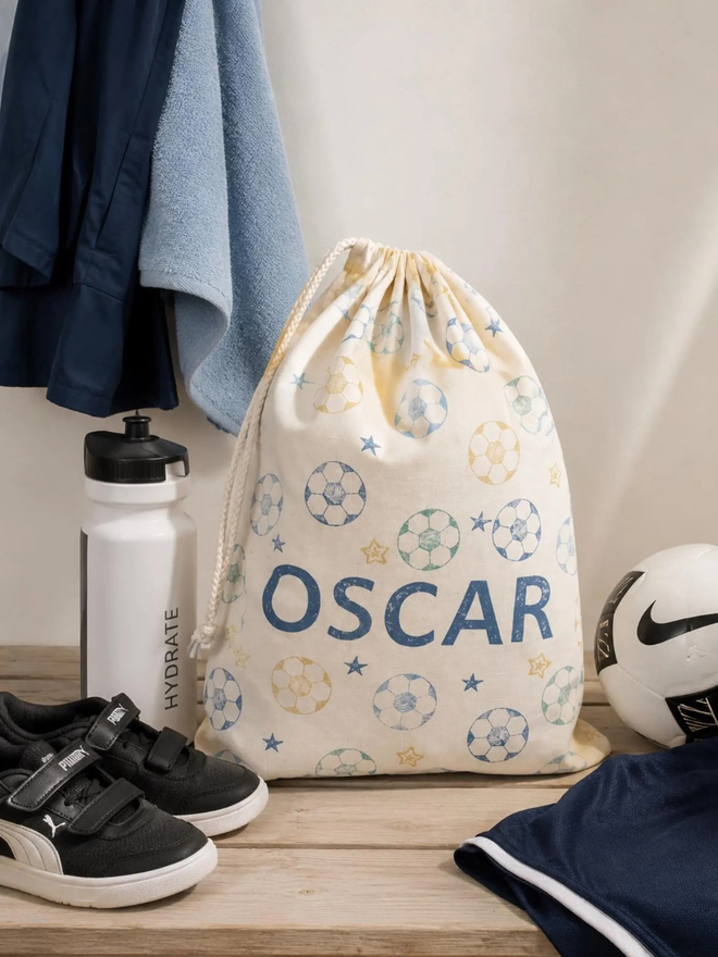 personalised football bag. a drawstring bag with printed footballs and a personalised name.