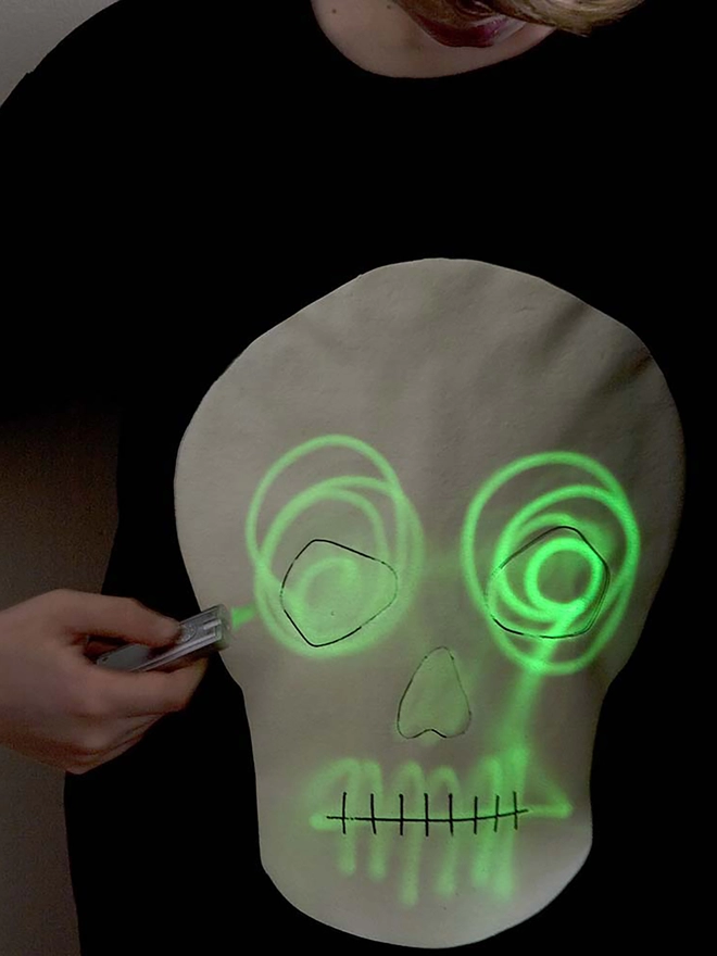 Hand drawing with torch onto glow in the dark skull tshirt