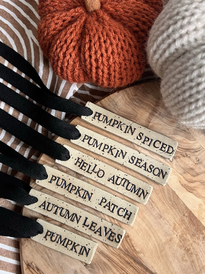 selection of ceramic tags in autumn phrases