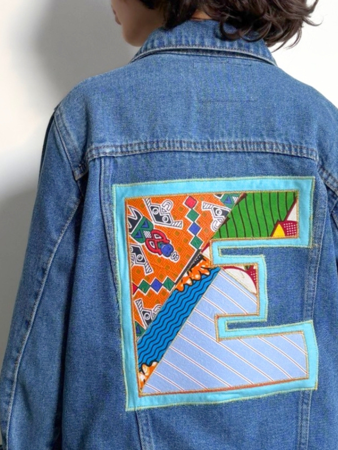 Upcycled vintage denim jacket stitched with a personalised initial monogram in bright vintage print fabric