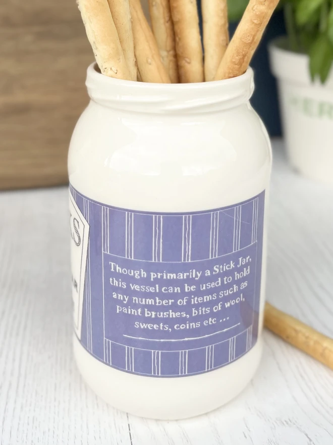 A beautifully handmade jar filled with breadsticks ready for dinner guests. 