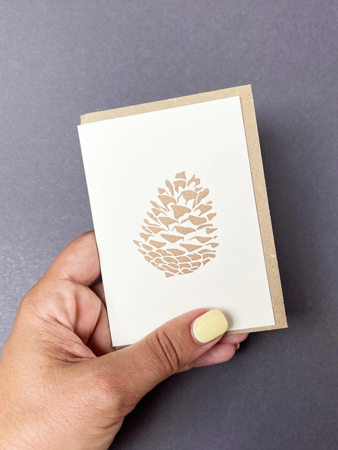 The metallic bronze/gold Pine cone on a little note card great to send for any occasion even Christmas