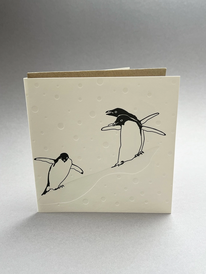 Penguin slide card stood up with an envelope insode