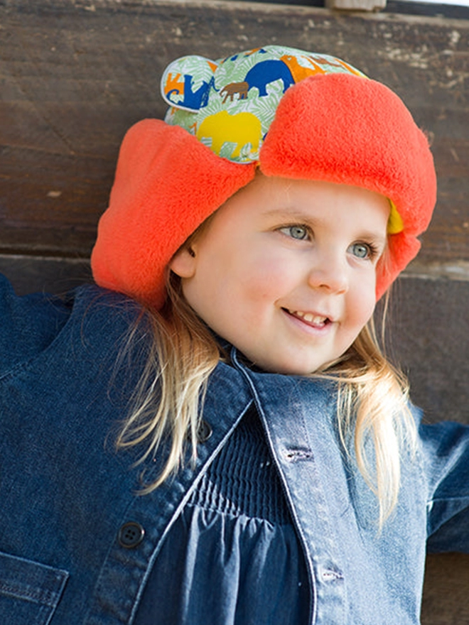 Girl wearing winter trapper hat in elefolk print