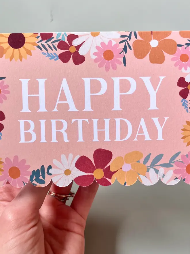 floral happy birthday card. scallop edged birthday card with illustrated flowers.