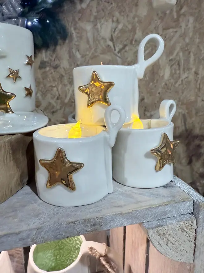 Porcelain Tea Light Holder Cup, set of three tea light holders stacked on a stand. 