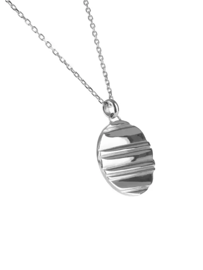 stunning silver coin pendant with linear design