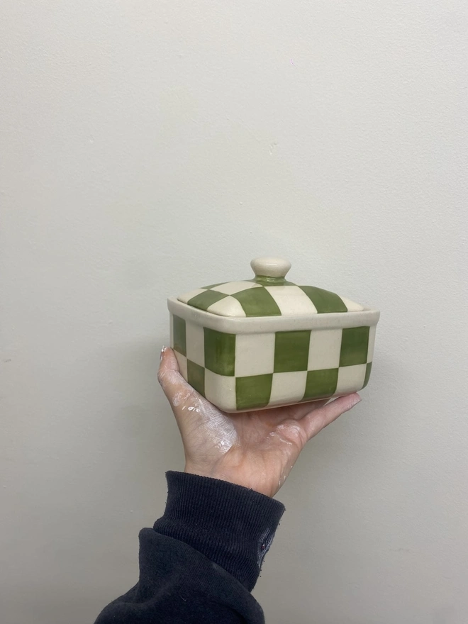  Checkered Green & Cream Handmade Ceramic Butter Dish, a green patterned butter dish held against a white backdrop. 