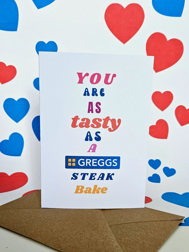 A humorous valentine greeting card that says you are as tasty as a Greggs Steak Bake in colourful text in different fonts