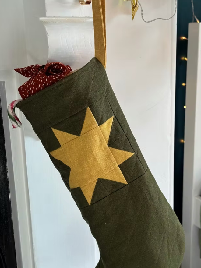 Large Star Linen Quilted Christmas Stockings. A green and yellow stocking.
