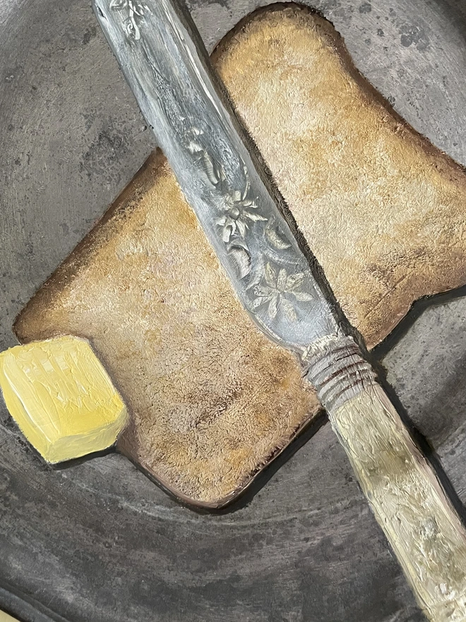 detail of painting of bread and butter on pewter plate 