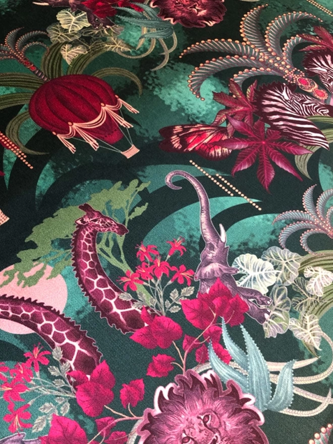 Close up of the green and pink velvet showing air balloons, giraffes and a lion