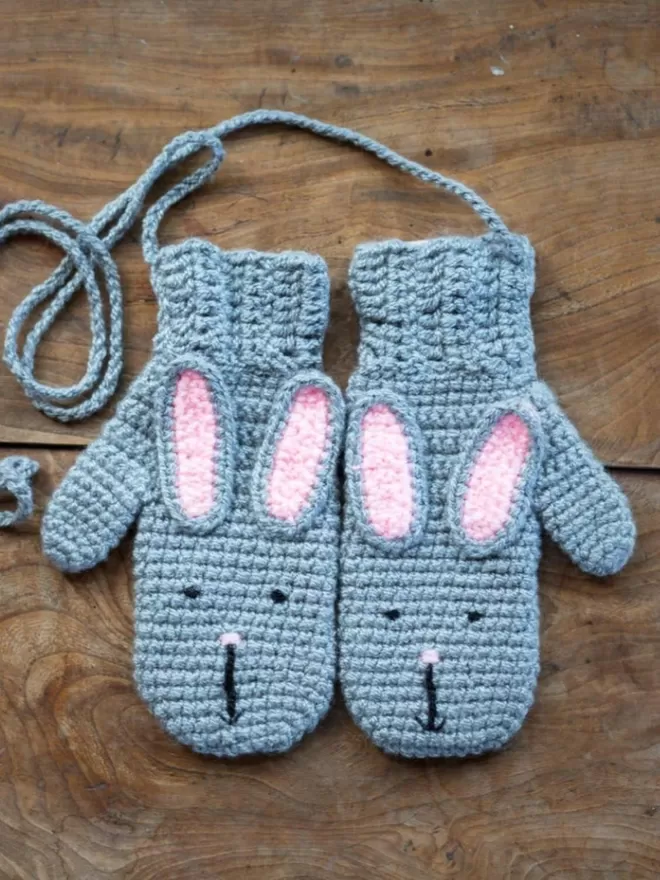 EKA Animal Mittens rabbit gloves seen on a wooden floor.