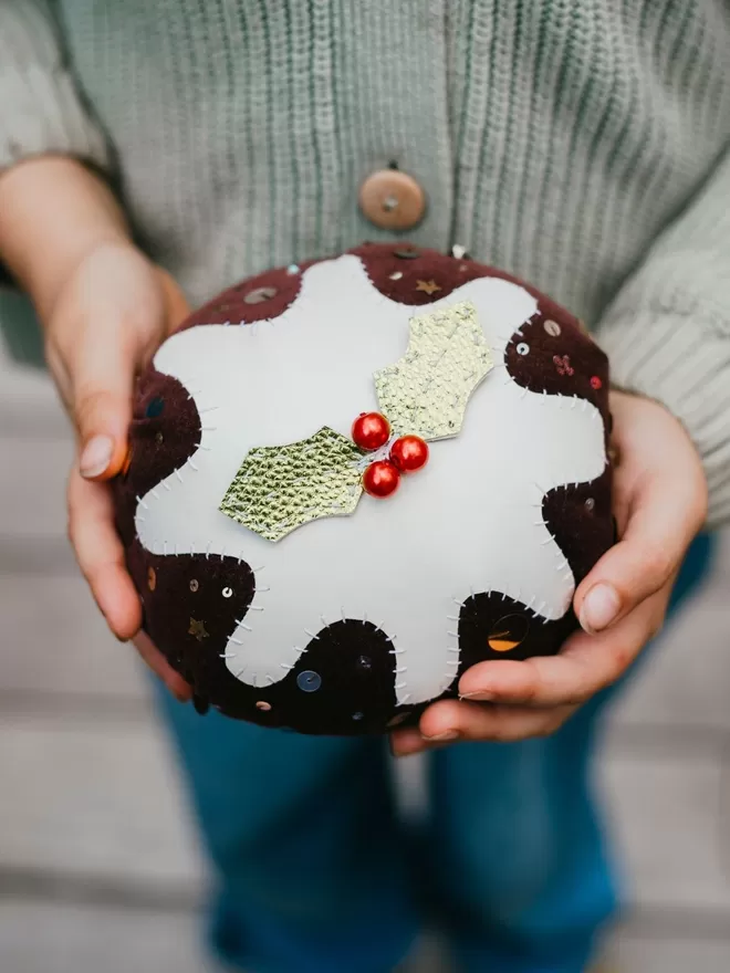 Christmas Pudding seen held by a child, seen from above.