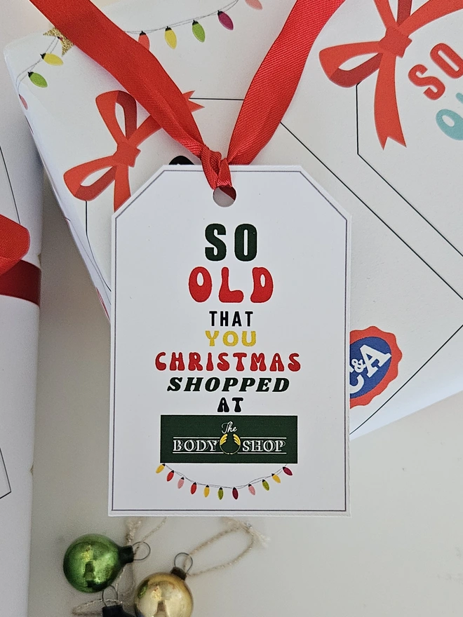 A gift tag on the present thats says so old that you Christmas shopped at The Body Shop to match the paper.