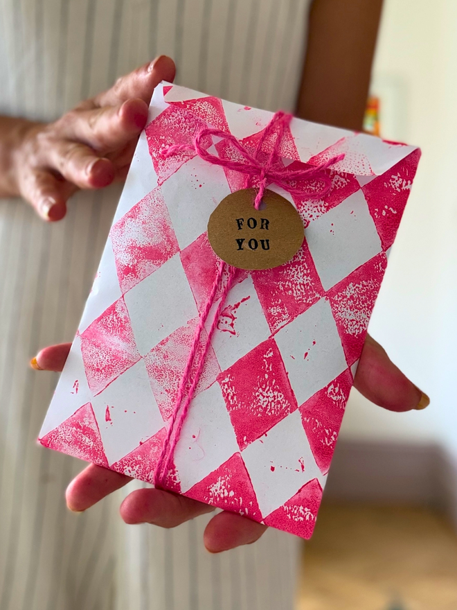 Gift wrap - pink harlequin hand printed paper with pink string tie and gift tag