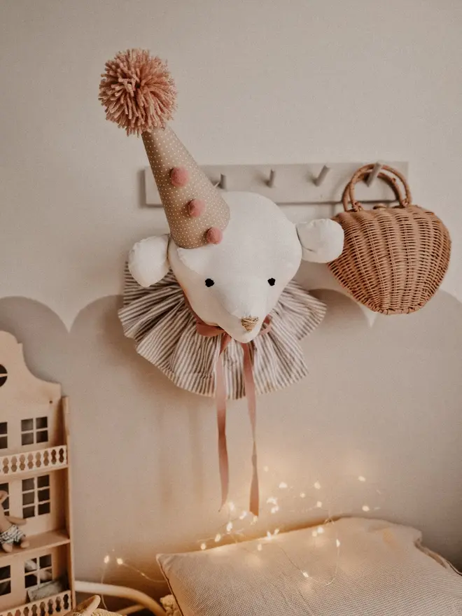 Bear Head Nursery Decoration, a bear decoration sitting against a wall in a child's decorated bedroom. 