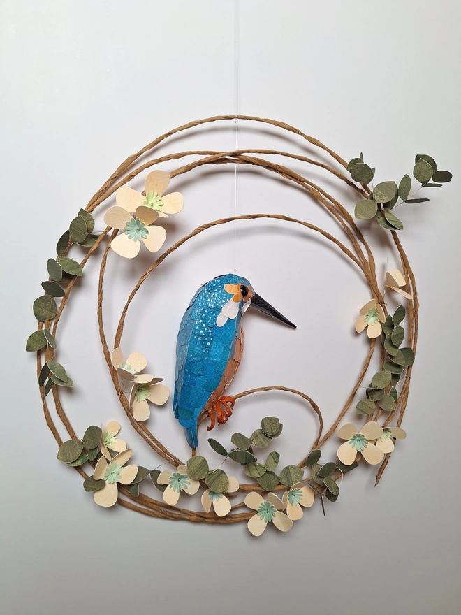 back view of a spring wreath wall hanging, featuring a kingfisher sculpture