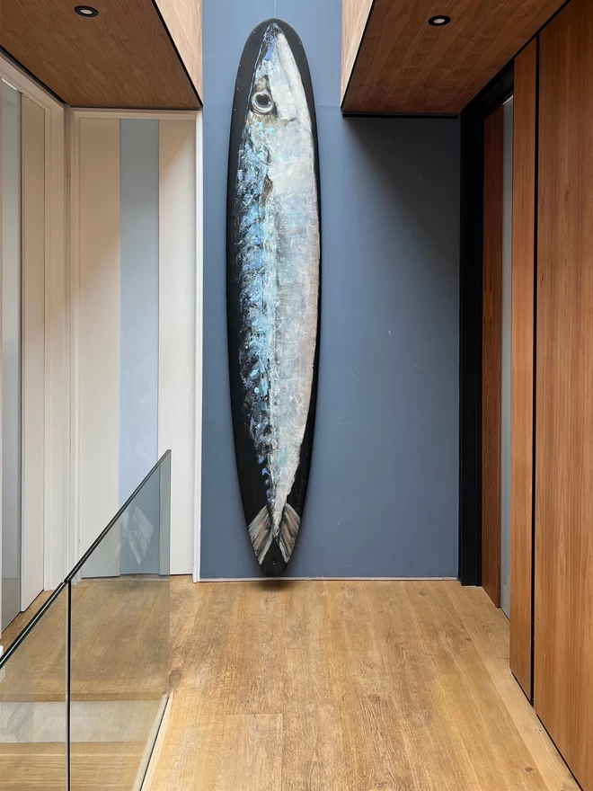big mackerel painted longboard shown in-situ in the hallway of a contemporary house